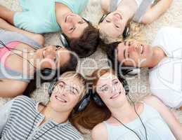 Group of friends listening to music on the floor