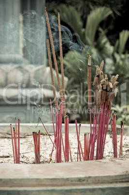 Burning incense in urn at buddhist pagoda