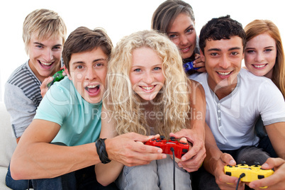 Portrait of teenagers playing video games in the living-room