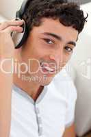 Portrait of teen guy listening to music