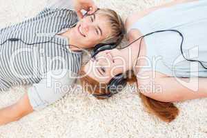 Couple of teenagers listening to music
