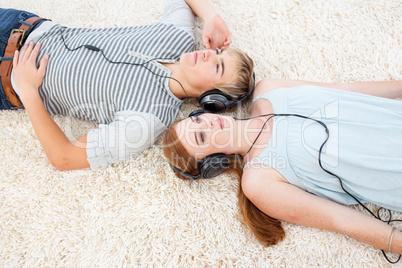 High angle of couple of teenagers listening to music
