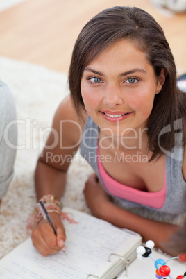 Beautiful teenager studying on the floor