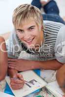Portrait of a teen guy doing homework
