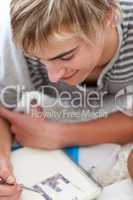 Teen guy studying on the floor with his friends