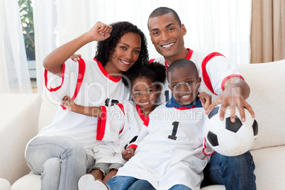 Afro-American family celebrating a football goal