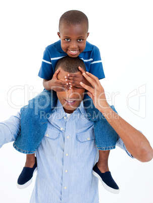 Close-up of a father giving son piggyback ride with closed eyes