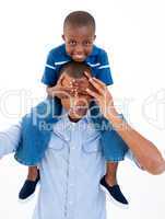 Close-up of a father giving son piggyback ride with closed eyes