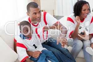 Excited Afro-American family wathing a football match