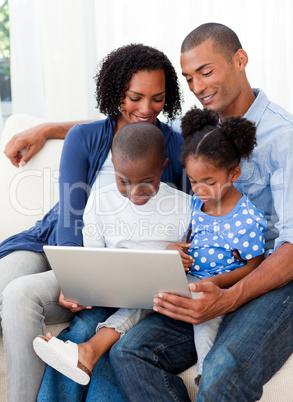 Happy family using a laptop