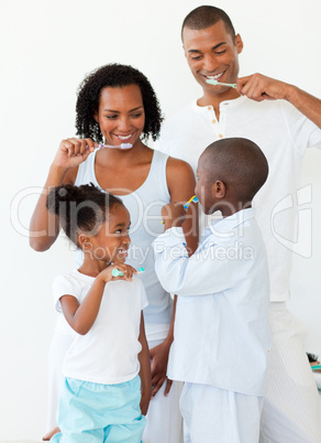 Portrait of a happy family brushing their teeth together