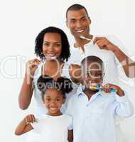 Afro-american family brushing their teeth