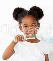 Portrait of an Afro-american girl brushing her teeth