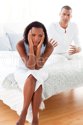 Angry couple sitting on the bed