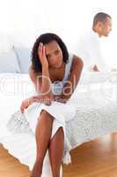 Upset couple sitting on the bed