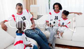 Afro-american family watching a football match