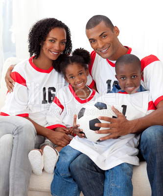 Smiling family holding a soccer ball