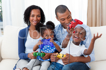 Happy Afro-american family playing video games