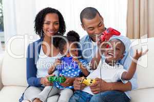 Happy Afro-american family playing video games