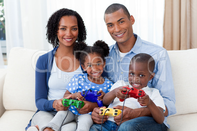 Smiling Afro-american family playing video games