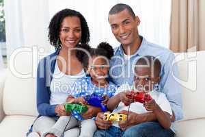 Smiling Afro-american family playing video games