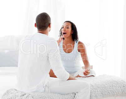 Couple on bed having an argument