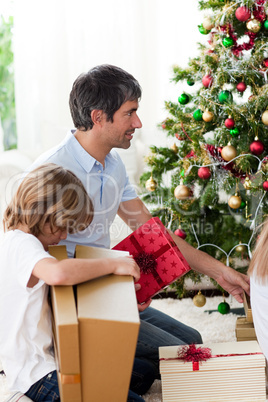 Father and his boy opening Christmas presents