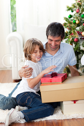 Happy father and his son holding Christmas presents