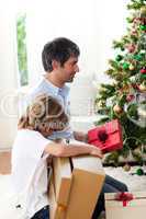 Father and his son opening Christmas gifts