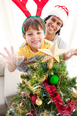 Father and son decorating a Christmas tree