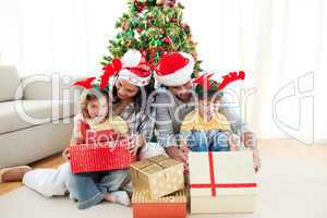 Family decorating a Christmas tree