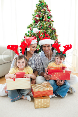 Family decorating a Christmas tree