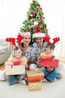 Family decorating a Christmas tree