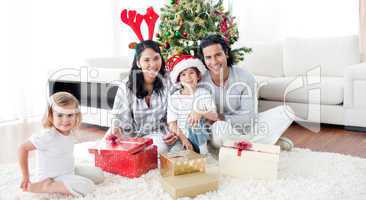 Family decorating a Christmas tree