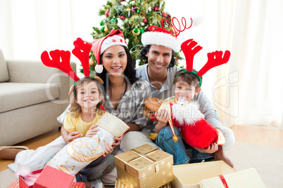 Family decorating a Christmas tree