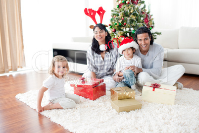Family playing with Christmas gifts at home