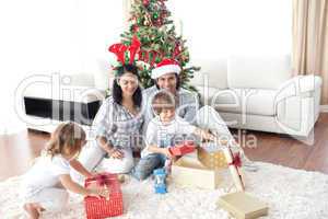 Family decorating a Christmas tree