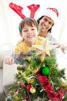 Father and son decorating a Christmas tree