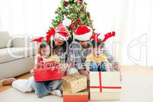 Happy family opening Christmas presents