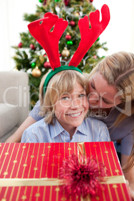 Loving mother kisses son at Christmas