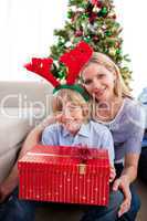 Portrait of a mother and her son holding Christmas gift