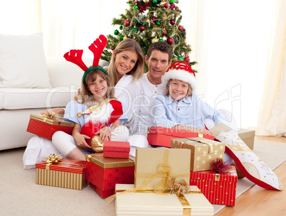 Happy family holding Christmas gifts