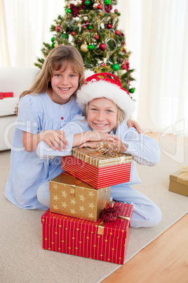 Happy brother and sister holding Christmas presents