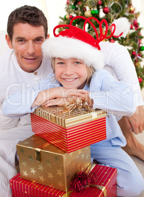 Portrait of a father and his son holding Christmas presents