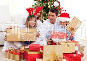 Young family having fun with Christmas gifts