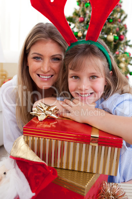 Portrait of a mother and her daughter holding Christmas presents