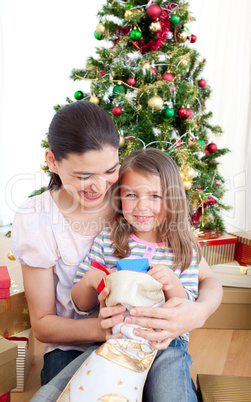 Mother and daughter playing with Christmas gifts