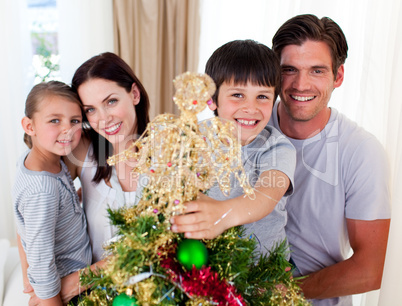 Portrait of a family decorating a Christmas tree