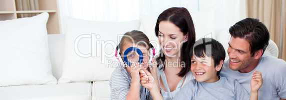 Happy family playing with a magnifying glass