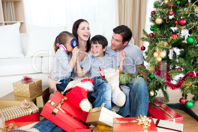 Happy family playing with Christmas gifts